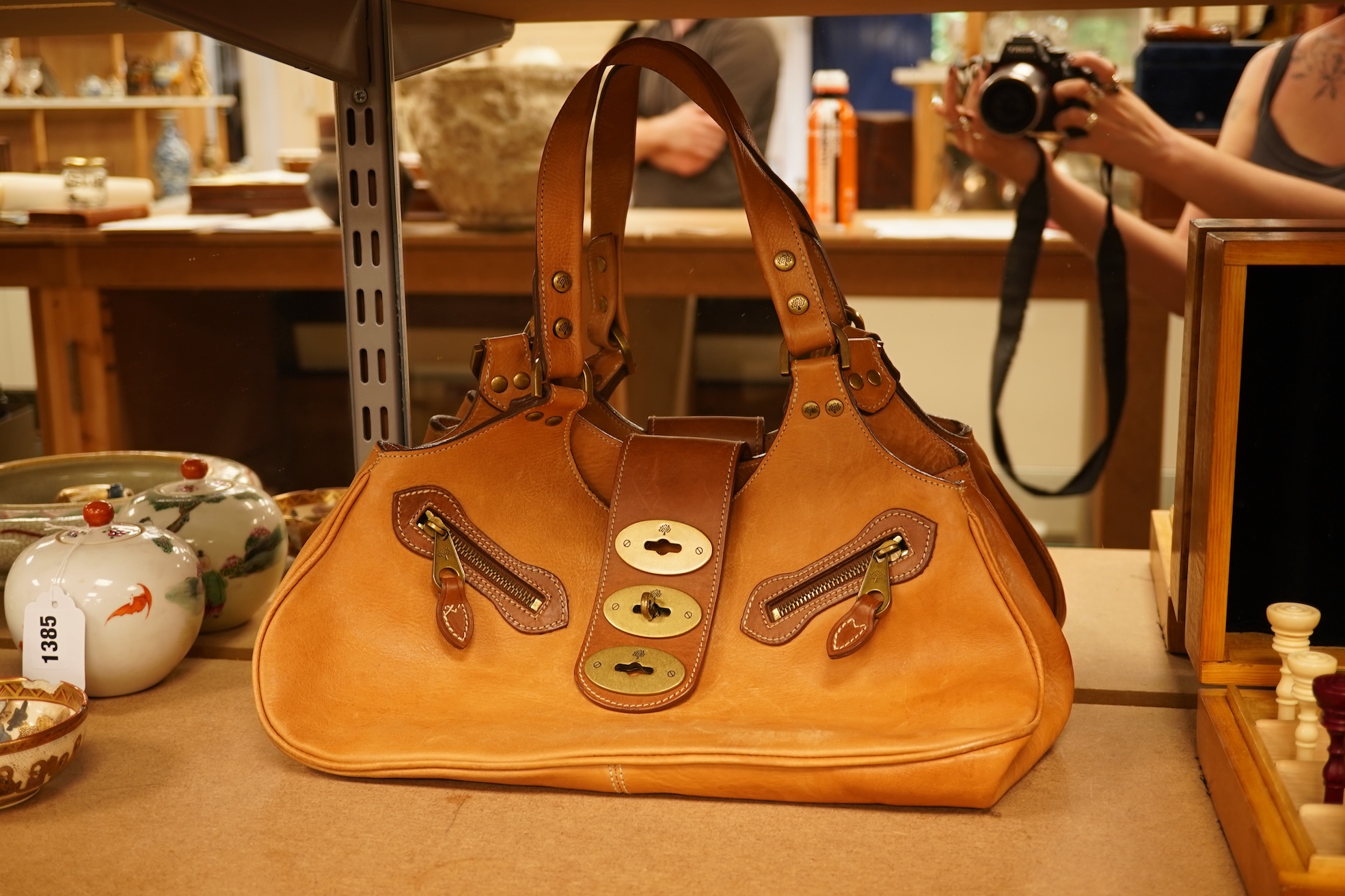 A Mulberry tote two zip, three postman clasps,tan leather with dark brown trim.handbag